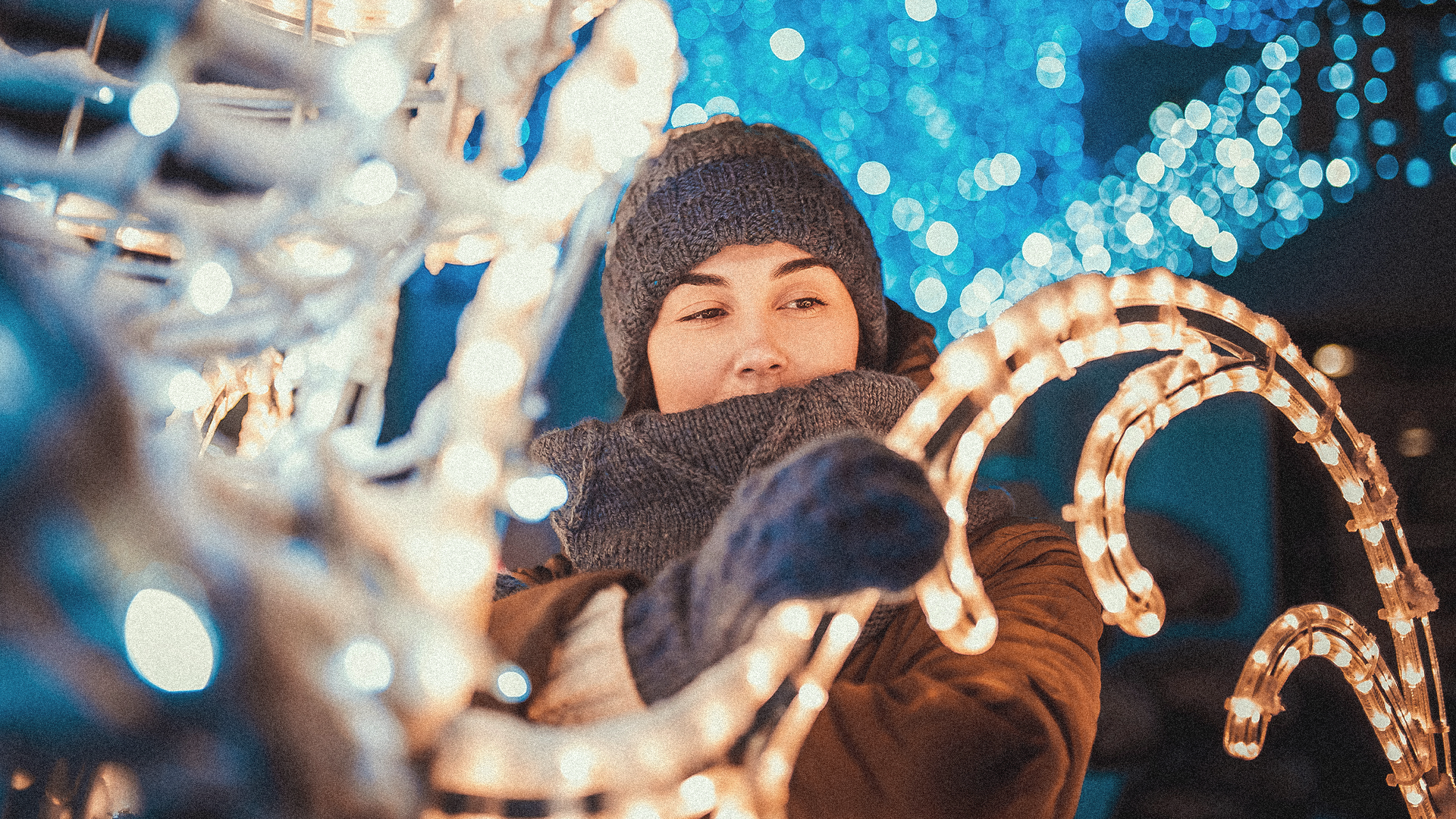 a woman admiring twinkling lights and seasonal decor during the holidays in Big Sky, Montana